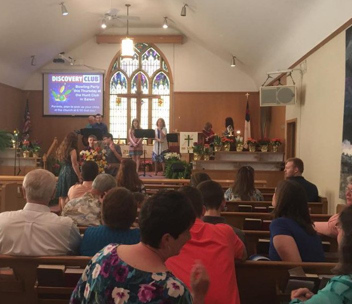The congregation gathered for Sunday worship in the sanctuary